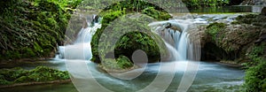 Small cascades with water flowing in the forest