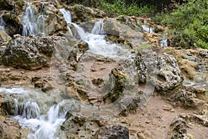 Small cascades of waterfalls on a mountain stream in the spring. Parod River. Israel