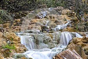 Small cascades of waterfalls on a mountain stream in the spring. Parod River. Israel