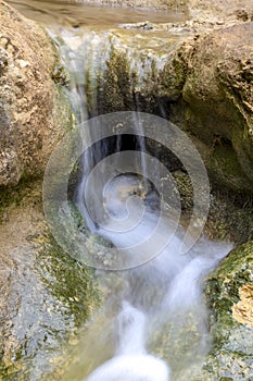 Small cascades of waterfalls on a mountain stream in the spring. Parod River. Israel