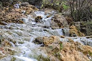 Small cascades of waterfalls on a mountain stream in the spring. Parod River. Israel