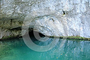 Small cave by lake Kaliderovac on Plitvicka Jezera in Croatia photo