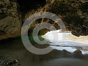 Small cave in Tsigrado beach in Milos Island photo