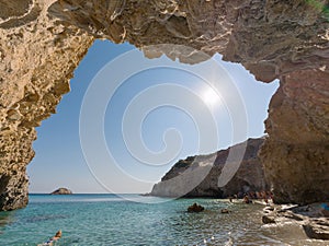 Small cave in Tsigrado beach in Milos Island photo