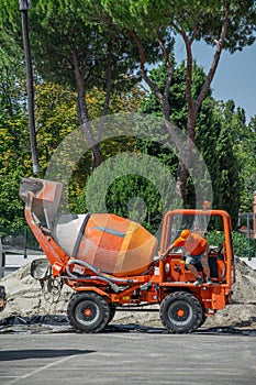 Small Cement truck transporting and turning dry cement by skilled operator