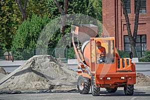 Small Cement truck transporting and turning dry cement by skilled operator