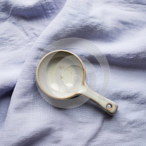 A small ceramic measuring spoon with