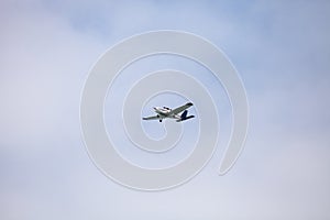 Small cessna 172 airplane soars through blue sky