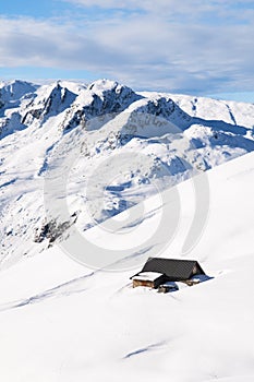 Chalet in Alps covered with snow