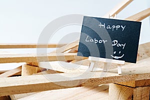 Small chalk board with text Happy Labor Day with wooden pallet b