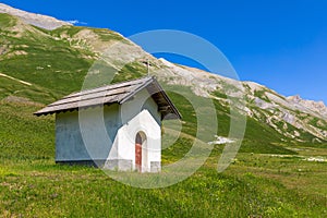 Small chapel on alpine meadow in France