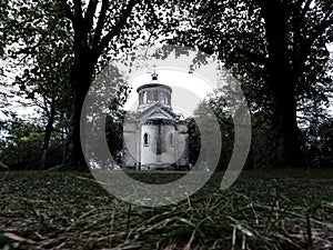 Gloomy view of the Sainte-Beatrix chapel in the forest photo