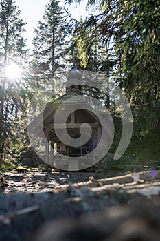 Small chapel in the forest in germany bavarian forest - Osserkapelle on the Osser. With heavy lensflare.