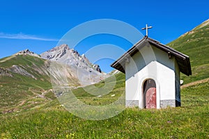 Small chapel on green alpine meadow in France