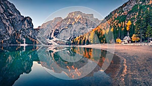 Small chapel on the shore of Braies Lake. Wonderful autumn scene of Dolomite Alps