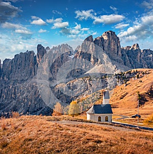 Small chapel on the top of Gardena pass with Piz Boe mountain on background.