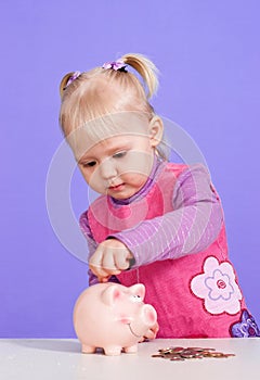 A small charming Caucasian baby plays