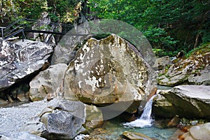Small charming waterfall in mountain forest
