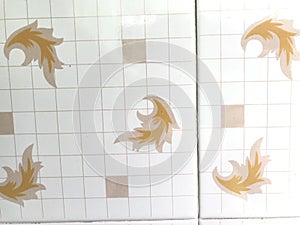 Small Checked boxes in white ceramic tiles with flora or flower design for kitchen wall background finish