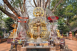 Small chedi surrounded by Buddha status at Wat Jed Yod, Chiang Mai, Thailand