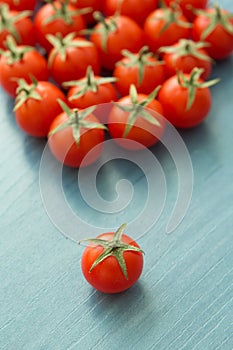 Small cherry tomatoes on a blue wooden