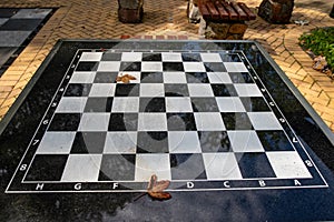 A small chess table in the park. Empty board game table