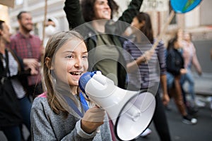 Small child with amplifier on global strike for climate change.