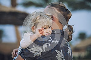 Small child in the arms of the father embracing the portrait