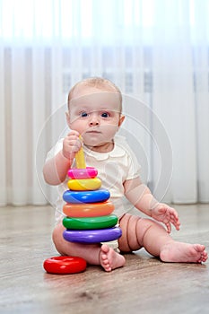 a small child with blue eyes is playing in the game room.