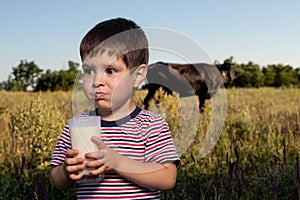 A small child boy 3 years old for the first time tastes cow`s milk, does not like milk, crooked, writhes the face. A boy in a