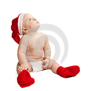 A small child in a Christmas hat and boots