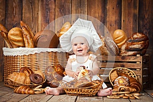 Small child cooks a croissant in the background of baskets with rolls and bread.