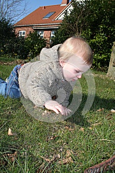 Small child crawling outside