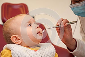 A small child at the dentist checks his baby teeth. Newborn child at the dentist