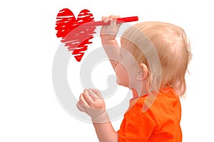 Small child draws red heart