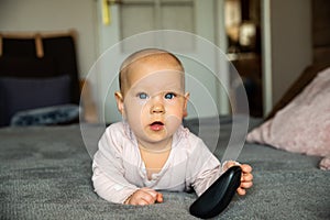 Small child, first steps on the internet, a newborn baby is holding a mouse from the computer