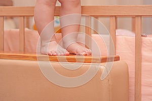 Small child legs near the cot