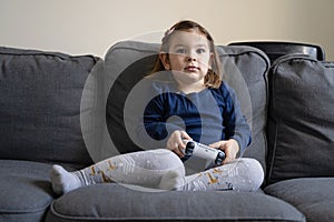 Small child playing video games with gamepad on console. Modern kids dependancy of virtual reality.