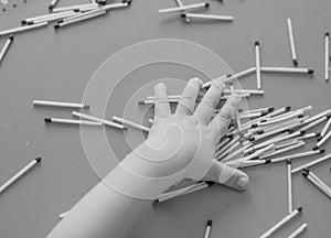 A small child plays with matches, takes matches from the table, close-up, black and white, fire, matches and child