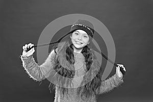 Small child ready for winter. kid fashion. Warm knitting tips. happy girl in earflap hat. holiday activity outdoor