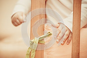 Small child standing in a crib