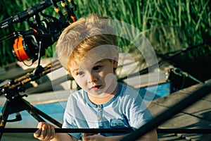 Small child with surprised face angling on river