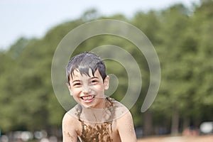 Small children bathe in water smear dirt on their body and rejoice