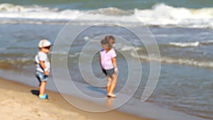 Small children play on the beach