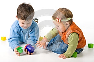 Small children play with blocks