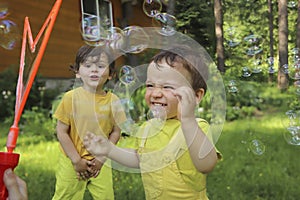 Small children play with soap bubbles