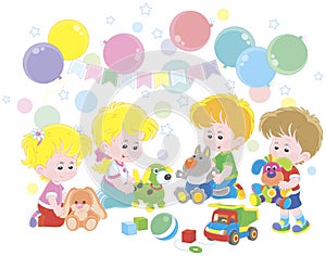 Small children playing colorful soft toys