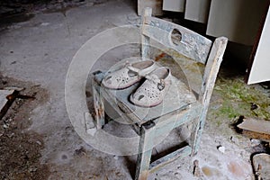 Small children`s sandals in an abandoned kindergarten in Pripyat. Old children`s shoes.