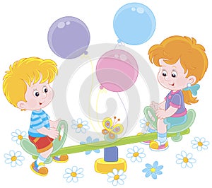 Small children on a toy swing on a playground