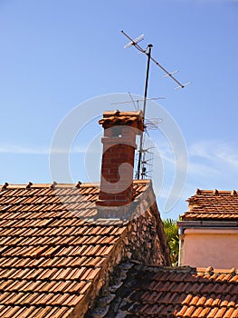 Small chimney on the roof of red tiles